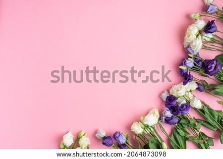 The composition of flowers and bags. A gift and flowers on a pink background. Women's Day, a holiday. Flat sunbed, top view, copy space.