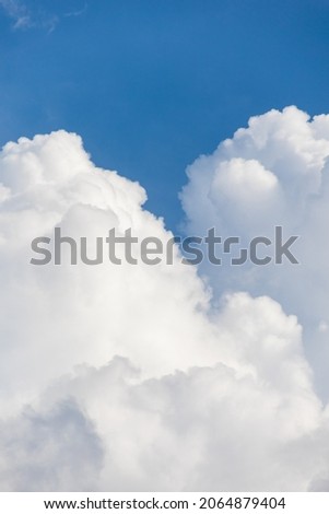 a large white cloud or cloud on a blue sky background. weather and weather conditions. a rain cloud or a storm. meteorology or observation of the weather and nature. rain or evening and a large cloud Royalty-Free Stock Photo #2064879404