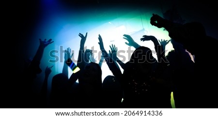 Photo of crazy bachelors enjoy dj rock star performance in private bar raise hands up dance shadow neon lights