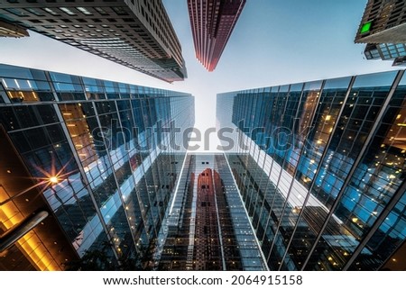 Business and finance concept, looking up at high rise office building architecture in the financial district of a modern metropolis. Royalty-Free Stock Photo #2064915158