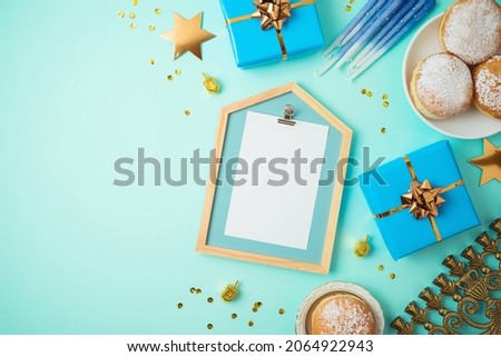 Top view image for Jewish holiday Hanukkah with traditional donuts, menorah, gift box and frame mock up 
