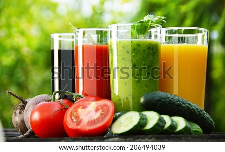 Glasses with fresh vegetable juices in the garden. Detox diet. Royalty-Free Stock Photo #206494039