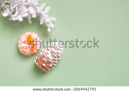 Top view Christmas and New Year decorations, pine cone, mandarin on a green background. Flat lay Handmade New Year soap. Xmas toys. Holiday concept, gifts and homemade soap