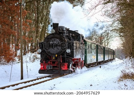 Historic steam train in winter Royalty-Free Stock Photo #2064957629