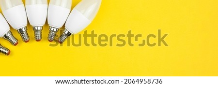 Energy-saving LED light bulbs, yellow background. Economical and environmentally frienfle light bulb concept. Banner, flat lay, top view, copy space photo