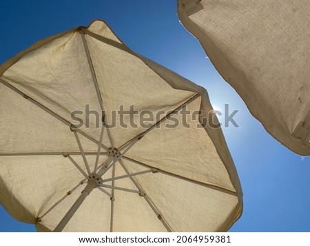 white umbrellas against a blue sky.