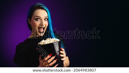Woman in black friday, shopping, expressions, with popcorn bucket in hand offering, blue hair surprise face, copy space, black background, neon style for websites, billboards and boards