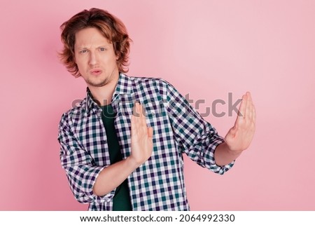 Photo of young handsome man negative gesture hands no stop sign refuse dislike isolated over pink color background