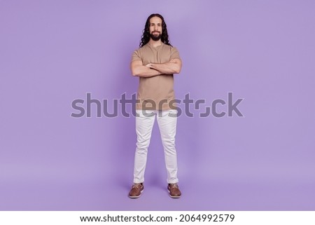 Full body photo of young handsome man folded hands wear casual outfit isolated on purple color background