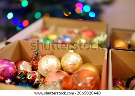 Variety of colorful Christmas baubles in a boxes. Trimming the Christmas tree. Celebrating Xmas at home.