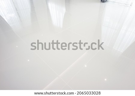 White tile floor with grid line of square texture pattern in perspective. Clean shiny of ceramic surface. Modern interior home design for bathroom, kitchen and laundry room. Empty space for background Royalty-Free Stock Photo #2065033028