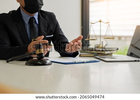 judge, male lawyer, business consultant legal services and consulting in various contracts to plan a court case hammer and scales of justice Businessman in a suit working on paperwork. Law