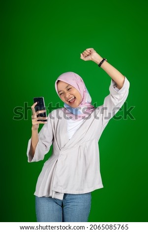 asian girl excitedly when looking at mobile phone screen