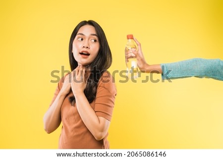thirsty girl offered with bottle of drinking water Royalty-Free Stock Photo #2065086146