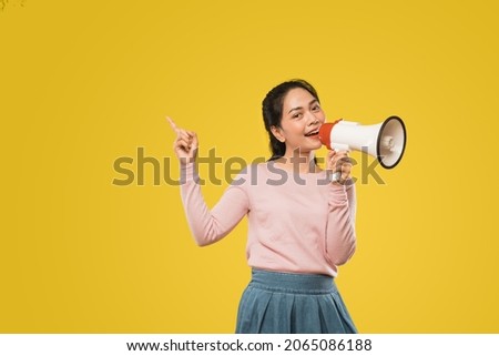 Asian girl with finger gesture pointing making announcement megaphone