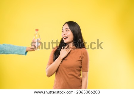 thirsty girl offered with bottle of drinking water Royalty-Free Stock Photo #2065086203