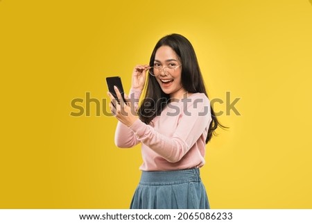 beautiful woman laughing looking at the screen of a smartphone