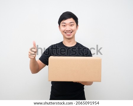 Man holding parcel box and show thumb up happy smile