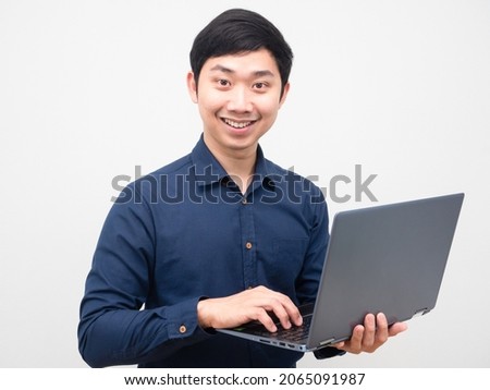 Asian man happy smile holding laptop white background