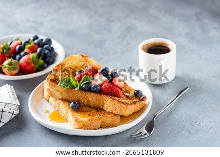Sweet french challah toast with berries and syrup served on plate. Copy space for text or design elements Royalty-Free Stock Photo #2065131809