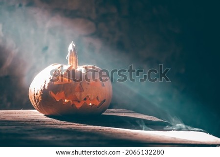 Jack O' Lanterns glowing in smoky fantasy night. Halloween background
