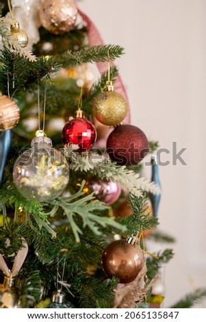 Christmas tree decorated with beautiful balloons and ribbons. Artificial spruce with decorative toys. concept is Christmas