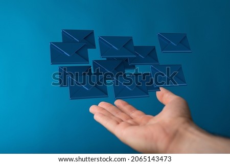 A 3D rendering of digital envelopes floating on hand- online communication concept