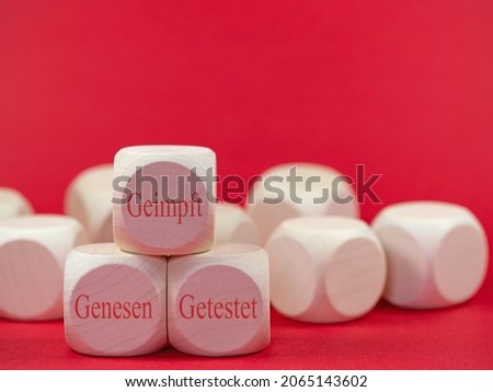 Wooden cubes with the imprint "Geimpft,genesen,getestet", translation"Vaccinated, recovered, tested" Royalty-Free Stock Photo #2065143602