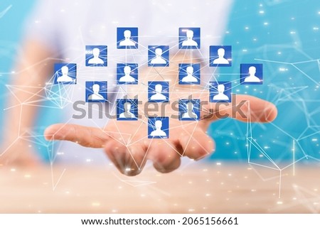 A 3D rendering of human icons floating on hand- digital work conference concept