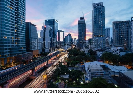 Sathorn Road is a route through the central business district of Bangkok with colorful twilight sky and blur trademark, brand, logo