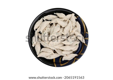 Top view of Meat or fish ball placed in a black plate  isolated on white background