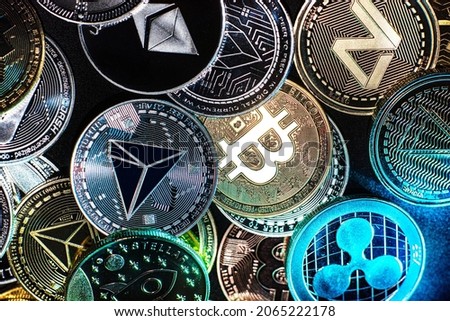 Horizontal view of cryptocurrency tokens, including Bitcoin, Tron, and Dash saw from above on a black background. High quality photo Royalty-Free Stock Photo #2065222178