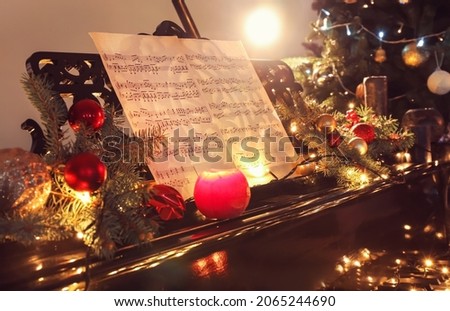 Grand piano decorated for Christmas in room, closeup Royalty-Free Stock Photo #2065244690
