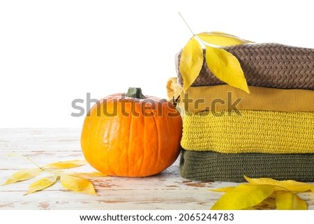 Stylish autumn clothes on table against white background