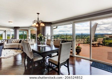 Elegant dining area with walkout deck in luxury house.