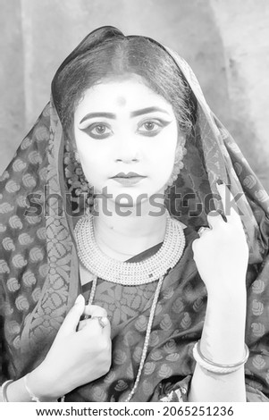 Portrait of beautiful village woman posing and wearing sari dress.