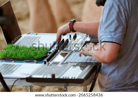 Disc jockeys hands playing music and remixing on drum machine midi controller. Professional DJs playing beat sampler with drum pads and samples. Deejays make beats on push button production controller