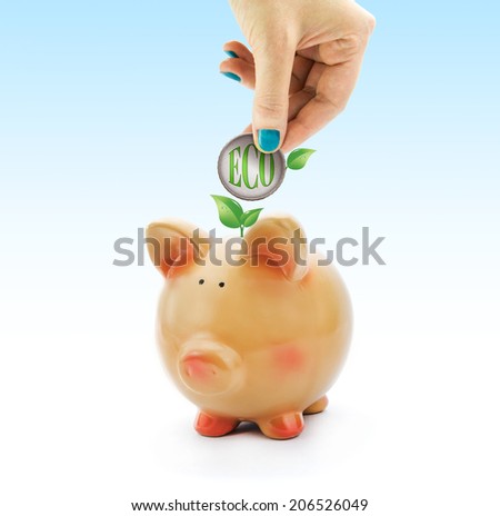 Hand depositing a coin with "eco" green text and leaves in piggy bank 