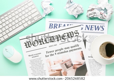 Composition with newspapers and computer keyboard on color background