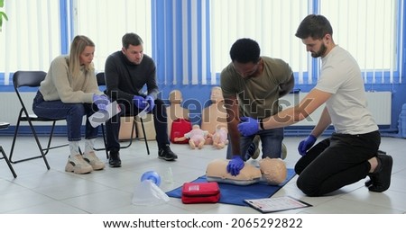 Group of people CPR First Aid Training course. CPR teen dummy first aid training. Royalty-Free Stock Photo #2065292822