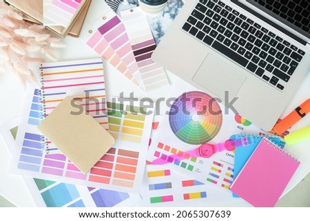 Modern laptop and color palettes on table of graphic designer in office Royalty-Free Stock Photo #2065307639