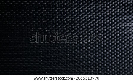 Mesh black texture. Dark polyester fiber material for sport cloth or abstract weave background. Synthetic pattern for backpacks and sports equipment