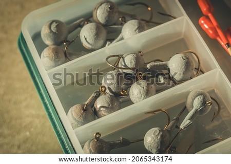 A set of fishing cargoes with hooks of different weights. Fishing box with accessories. Selective focus Royalty-Free Stock Photo #2065343174