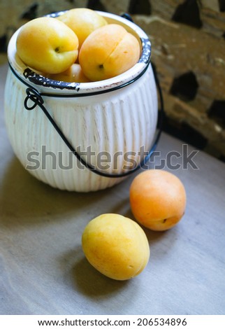 Sweet ripe apricots in small buckets. Selective focus.