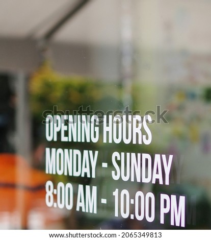 Opening hours shop window white sticker monday to sunday 8am to 10pm