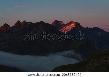 Warm sunset at Pyrenees mountain range. This side of the Pyrennes, is the border between France and Spain. Orange and teal colors are the main on this picture.