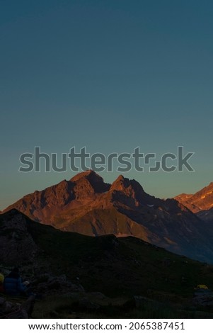 Warm sunset at Pyrenees mountain range, border between France and Spain. Orange and teal colors are the main on this picture.