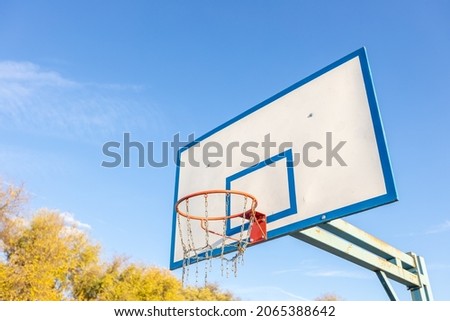 Basketball hoop on the background of yellow autumn trees