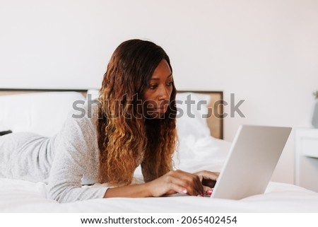 A black female working from home with her notebook