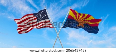 two flags of USA and state of Arizona waving in the wind on flagpoles against sky with clouds on sunny day. 3d illustration